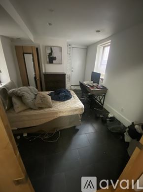 Boston apartment for rent - A bedroom with a bed, desk, and chair.