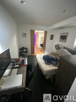 Boston apartment for rent - A room with a bed, desk, and computer.