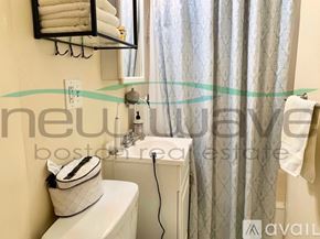 Boston apartment for rent - A white toilet with a white towel and a white bag on it.