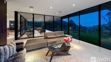 Los Angeles house for rent - A modern living room with a large couch and a coffee table.