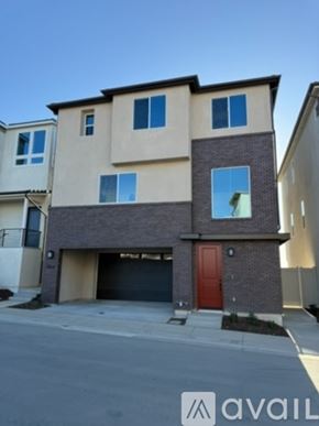 San Marcos house for rent - A two-story house with a red door and a garage.