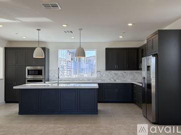 San Marcos house for rent - A modern kitchen with dark cabinets and a large island.
