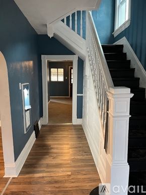 Pittsburgh house for rent - A hallway with a staircase and a doorway.