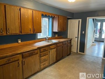 Pittsburgh house for rent - A kitchen with wooden cabinets and a sink.