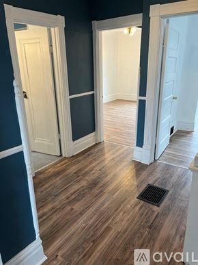Pittsburgh house for rent - A hallway with white doors and a wooden floor.