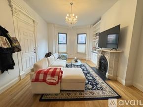 Boston apartment for rent - A room with wooden flooring and a chandelier.