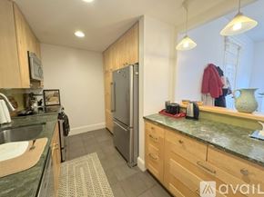 Boston apartment for rent - A room with wooden flooring and a window with a view of a building outside.