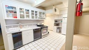 Hartford condo for rent - A kitchen with white appliances and cabinets.