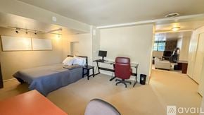 Hartford condo for rent - A bedroom with a bed, desk, and chair.