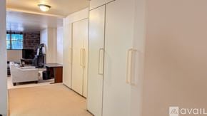 Hartford condo for rent - A room with a white chair and a white cabinet.