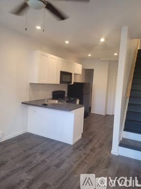 Philadelphia apartment for rent - A kitchen with a black countertop and white cabinets.