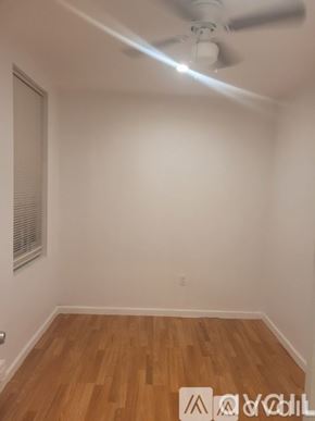 Philadelphia apartment for rent - A room with a ceiling fan and wooden flooring.
