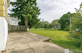 Irondequoit house for rent - A dining room with a white table and chairs.