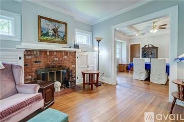 Irondequoit house for rent - A living room with a fireplace and a painting on the wall.