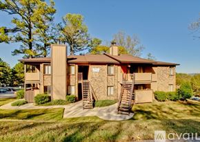 Huntsville apartment for rent - A two-story building with a brown roof and a stone facade.