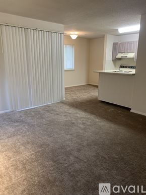 Huntsville apartment for rent - A room with a carpeted floor and a window with blinds.