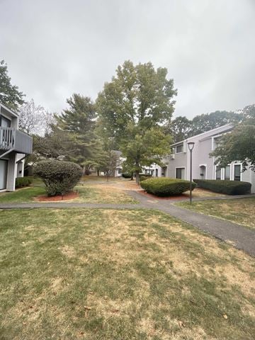 State College apartment for rent - A grassy area with a walking path in front of a building.
