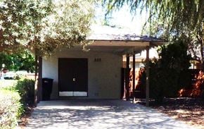Modesto house for rent - A house with a black trash can in front of it.