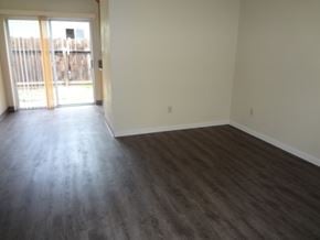 Modesto house for rent - A room with a sliding glass door and wood flooring.