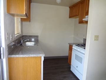 Modesto house for rent - A kitchen with a white stove and a sink.