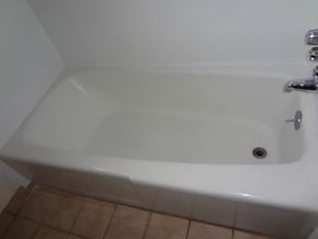 Modesto house for rent - A white bathtub with a faucet and a drain is in a bathroom.