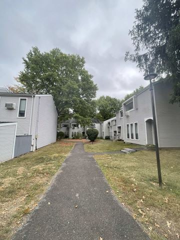 State College apartment for rent - A pathway leads through a grassy area between two buildings.