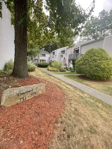 State College apartment for rent - A sign in front of a tree reads "Courtyard 751-779".