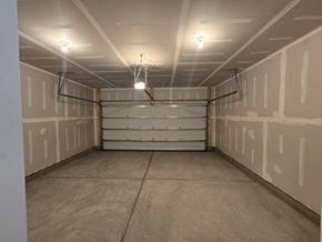 Morrisville house for rent - A spacious room with a long shelf and fluorescent lights.