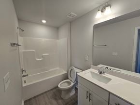 Morrisville house for rent - A white bathroom with a toilet, sink, and bathtub.