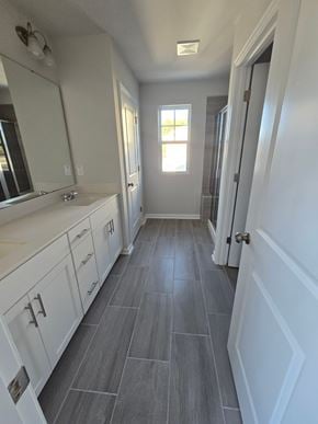 Morrisville house for rent - A bathroom with a white vanity and a large mirror.
