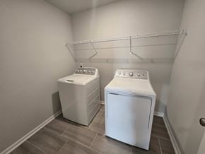 Morrisville house for rent - Two white front loading washing machines in a laundry room.