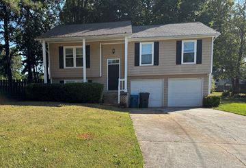 Lawrenceville house for rent - A house with a grey roof and a white garage door.
