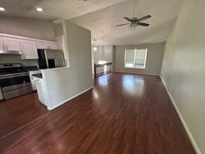 Lawrenceville house for rent - A room with wooden floors and a ceiling fan.