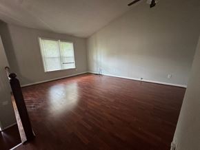 Lawrenceville house for rent - A room with wooden flooring and a window with blinds.