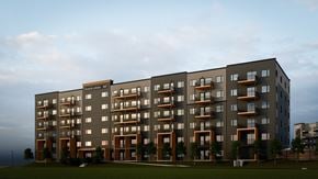 Saskatoon apartment for rent - A modern apartment building with balconies and a sign that reads "Bank of Scotland 200".