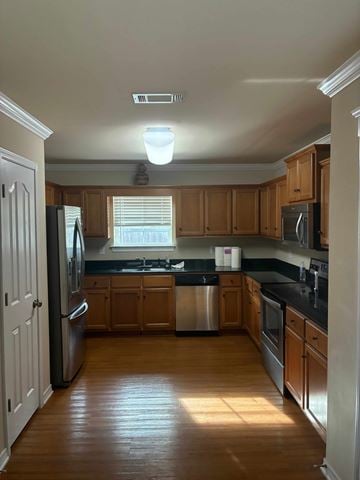 Mobile house for rent - A kitchen with wooden cabinets and a stainless steel refrigerator.