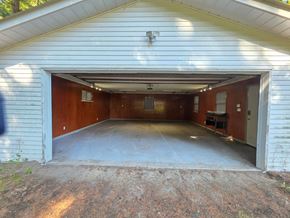 Langley apartment for rent - A garage with a white siding and a brown door is shown.