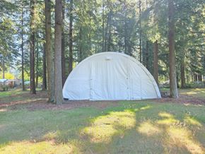Langley apartment for rent - A white dome tent is set up in a grassy area surrounded by trees.
