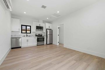 Granada Hills house for rent - A kitchen with white cabinets and stainless steel appliances.
