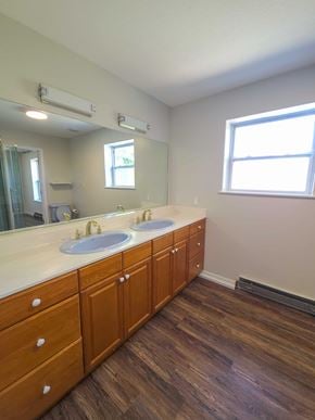 La Veta house for rent - A bathroom with two sinks and wooden floors.