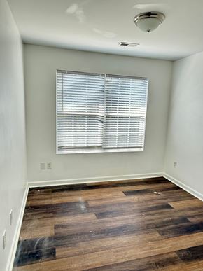 Hampton house for rent - A room with wooden flooring and a window with blinds.