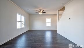 Chelsea house for rent - A spacious room with a ceiling fan and wooden flooring.