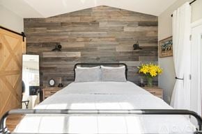 Buellton house for rent - A bedroom with a bed, nightstands, and a wooden wall.