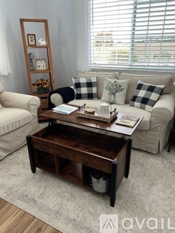 Buellton house for rent - A living room with a wooden coffee table in the center.