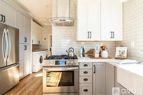 Buellton house for rent - A modern kitchen with a stainless steel refrigerator and a stove top oven.