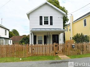 Berryville house for rent - A white house with a wooden fence in front of it.