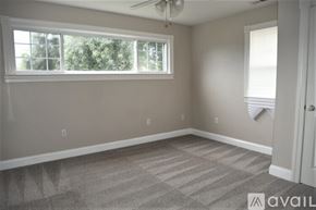 Berryville house for rent - A room with a carpeted floor and a window.