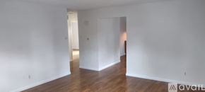 Gloucester Township apartment for rent - A bathroom with a toilet and a shower curtain with a pattern.