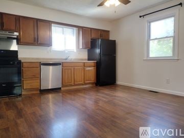 Gloucester Township apartment for rent - A kitchen with wooden cabinets and a black refrigerator.