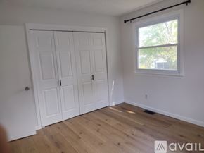 Gloucester Township apartment for rent - A room with a white door and a window with a view of trees outside.
